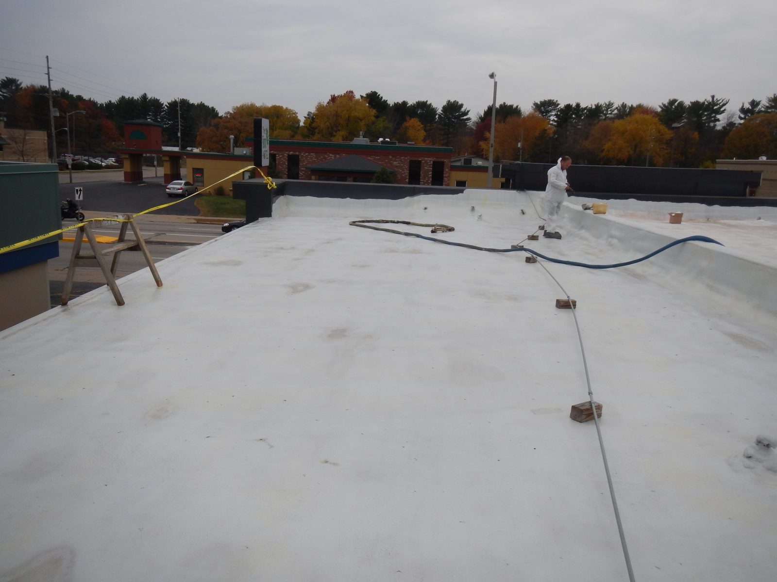 Exposed-fastener steel roof panel showing screw lines and side laps