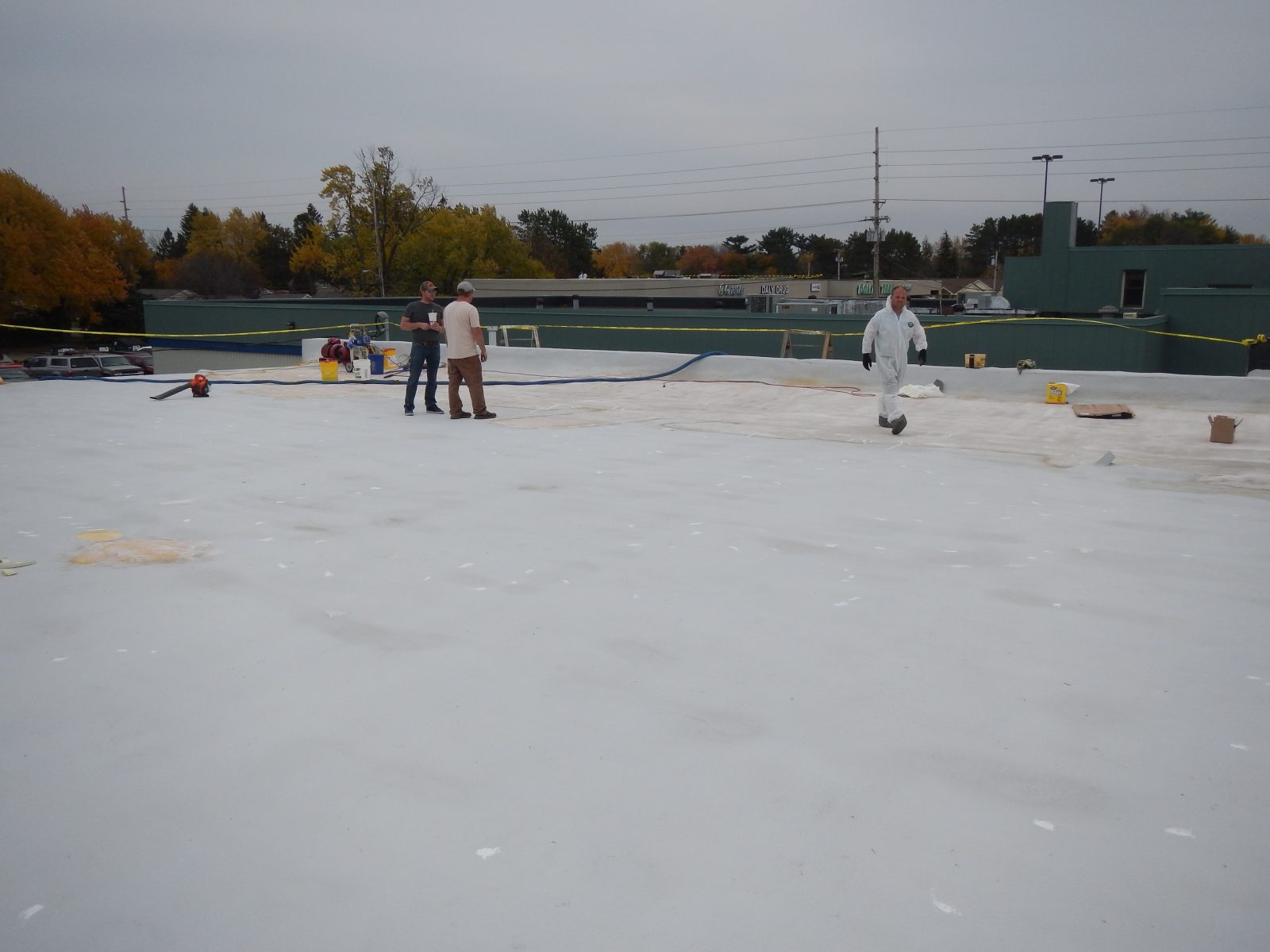 Pole barn steel roof being restored with a polyurea membrane