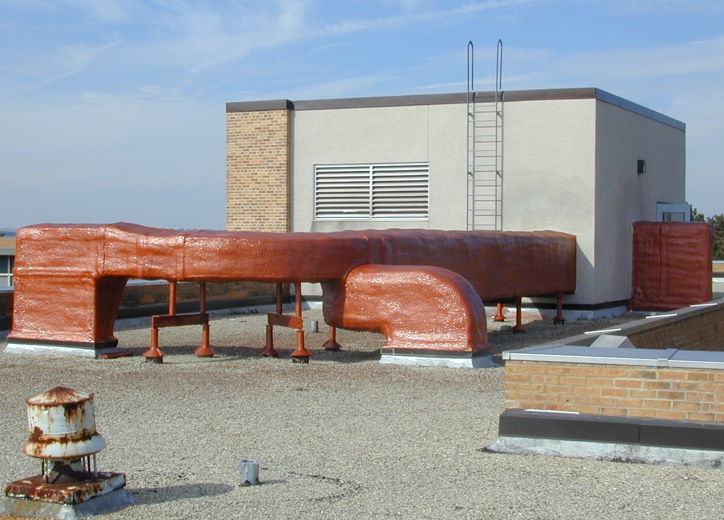 Commercial steel deck roof assembly being coated